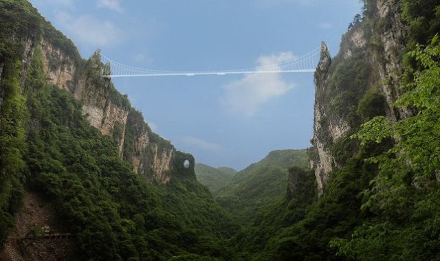 The Zhangjiajie Grand Canyon Glass Bridge stretches across a 1,200-foot canyon. (Image courtesy of Haim Dotan Ltd.)