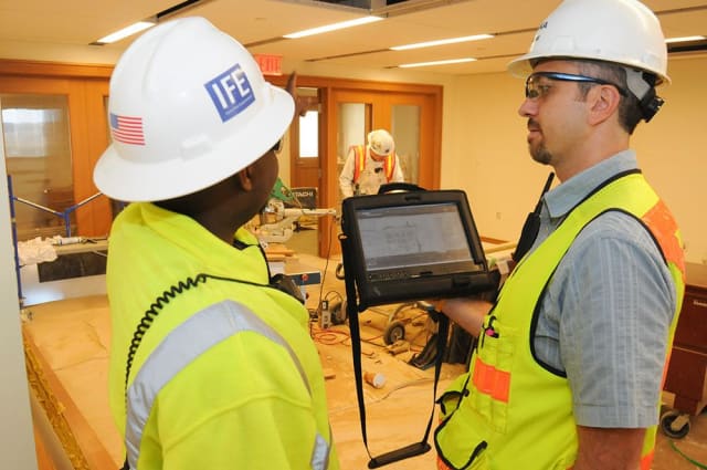 Lance Borst (right) and his team manage punch lists via tablet at the Novartis site in Cambridge, Massachusetts. (Image courtesy of Skanska.)