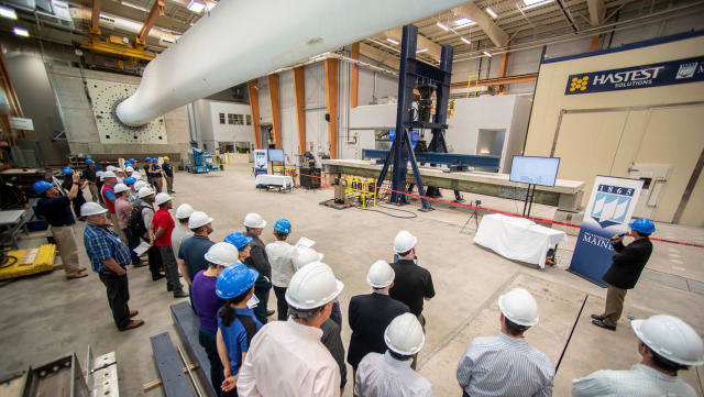 The University of Maine’s Advanced Structures and Composites Center tests the strength of their new composite girders at a ceremony on July 12th. (Image courtesy of University of Maine.)
