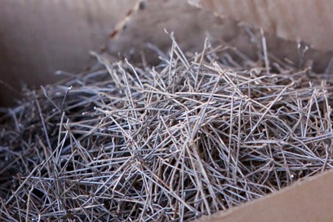 Steel wires, ready to be made into steel fiber-reinforced concrete. These ones have small deformations (“hooks”) at both ends to anchor them in the concrete (Image courtesy of CoGripedia.)