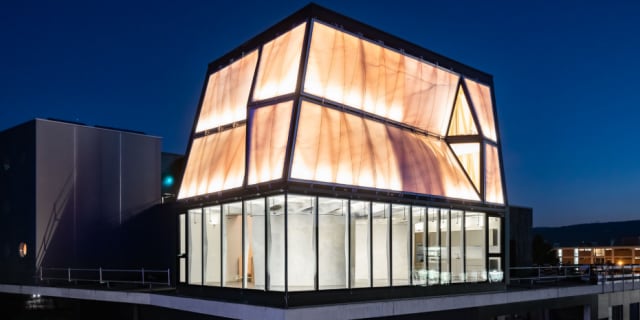 DFAB House at night. The house is built on top of the Next Evolution in Sustainable Tech building. (Image courtesy of Roman Keller/ ETH Zurich.)